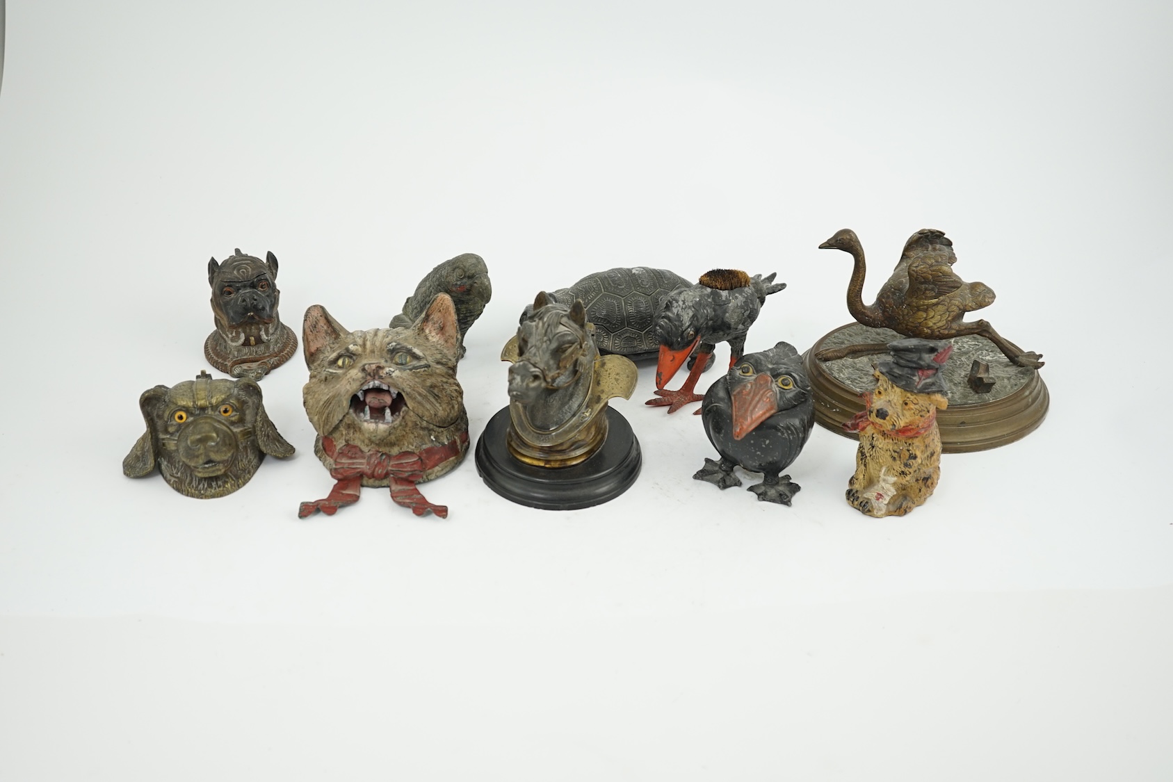 A collection of nine 19th and 20th century novelty animal bronze and metal ink wells, including a Martin Brothers-style ‘Wally’ inkwell. Condition - minor chips due to use and age